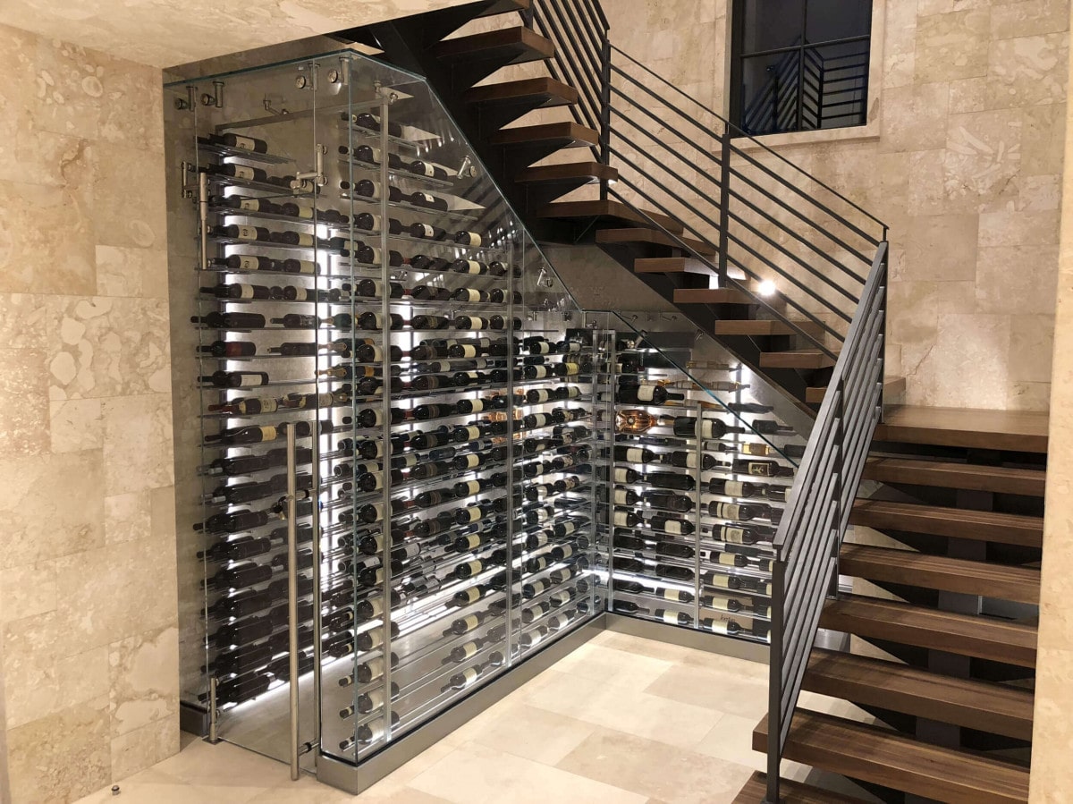 glass wine cellar under stairs