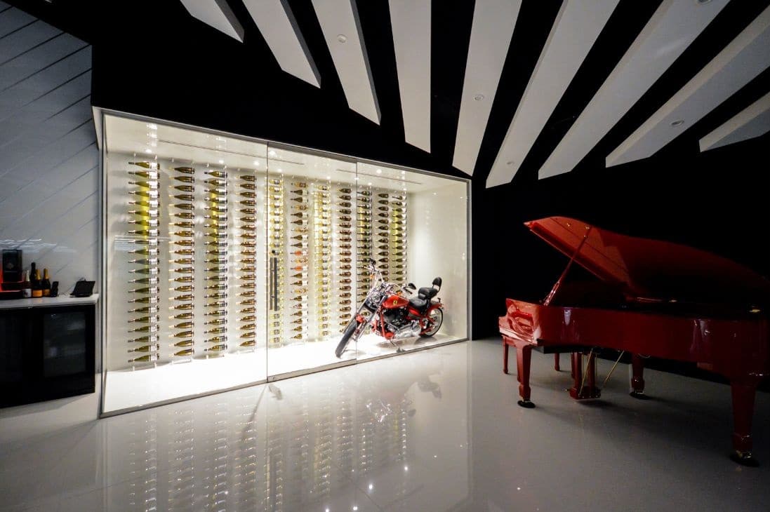 Glass enclosed wine wall with motorcycle