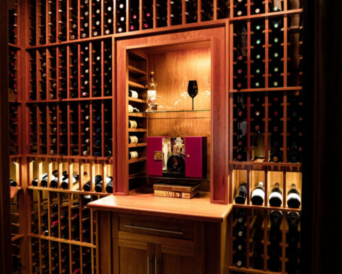 Traditional style wine cellar design with display for trophy bottles - Genuwine Cellars